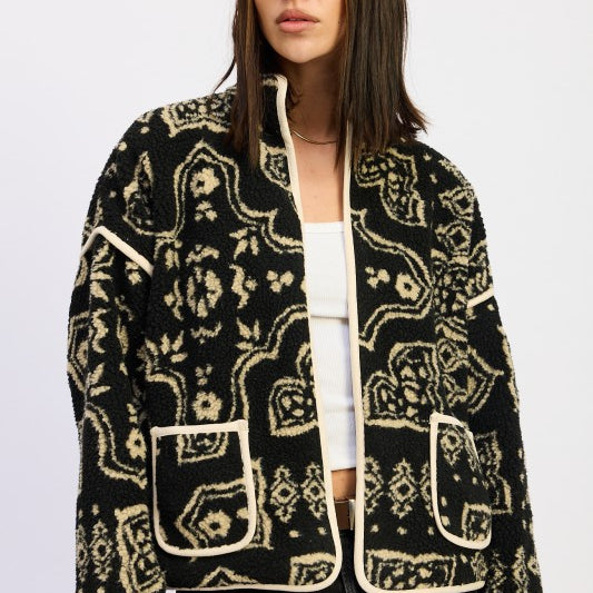 Model wearing black and taupe sherpa jacket with open front and printed design- AVAH
