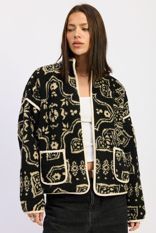 Model wearing black and taupe sherpa jacket with open front and printed design- AVAH