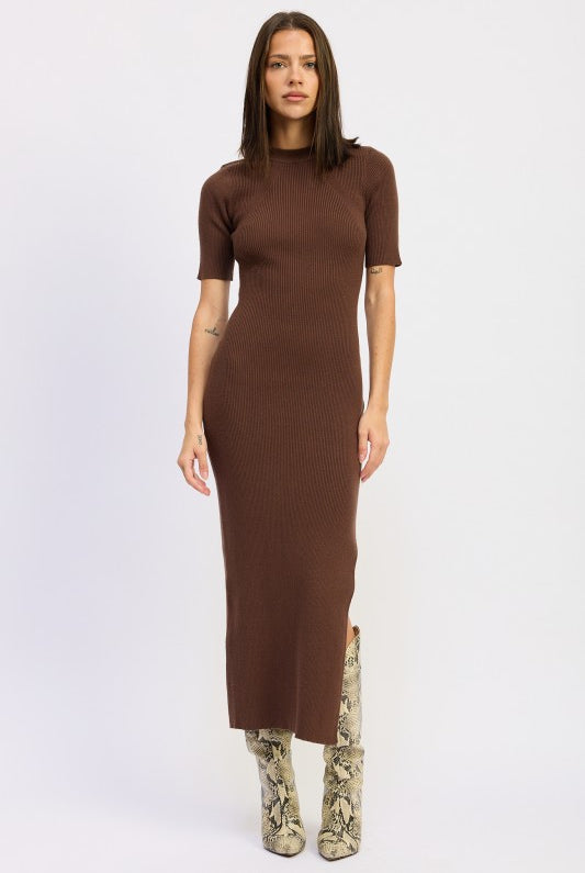 Model wearing mocha ribbed midi dress with short sleeves and snake boots.