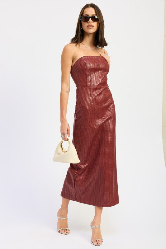 Side view of burgundy strapless textured midi dress with sleek finish, paired with silver heels and ivory bag