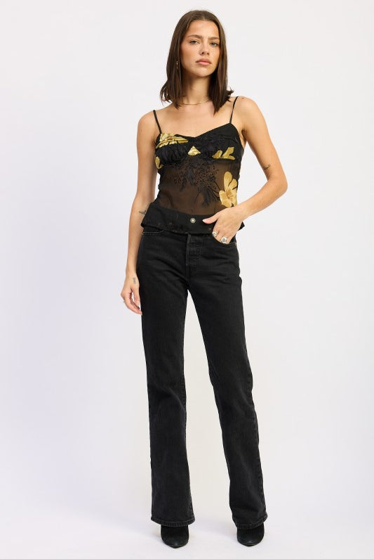 model styled in black floral print mesh cami top with high-waist denim