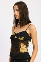 side angle of sheer floral cami showing adjustable straps and layered lining
