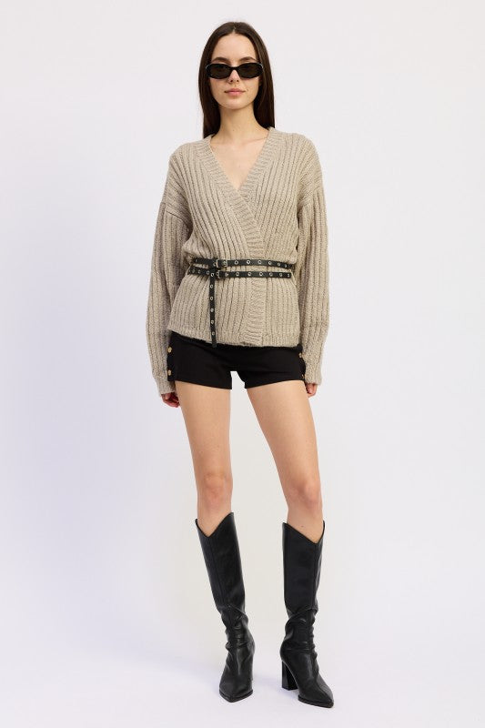 Full outfit view of warm grey belted knit sweater styled with shorts and knee-high boots