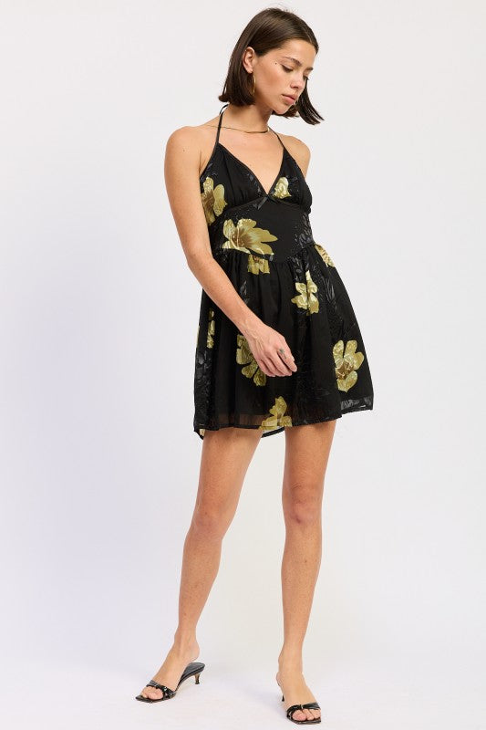 Angled front view of black mini dress with gold floral print