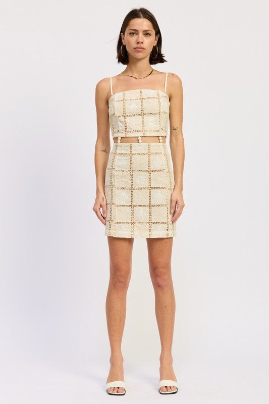 Full front view of cream crochet grid mini dress on model.