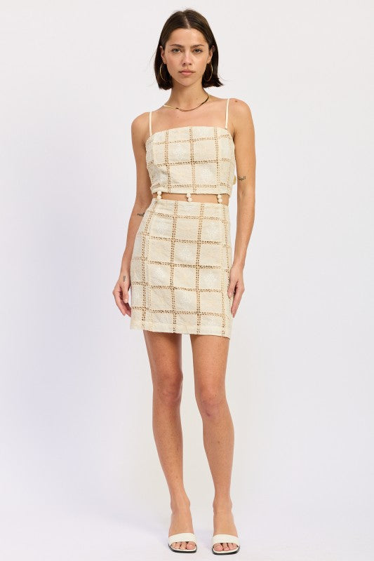 Full front view of cream crochet grid mini dress on model.