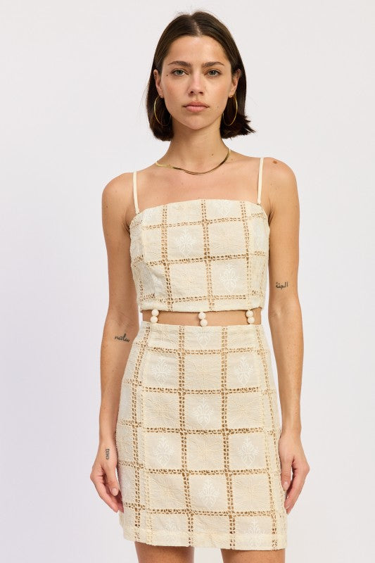 Model wearing cream crochet mini dress with lattice texture and straight neckline, front view- AVAH