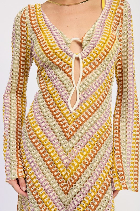 Close-up of the Sunwoven Chevron Long Sleeve Maxi Dress showing the chevron crochet-inspired knit texture, deep V neckline, and adjustable tie detail.
