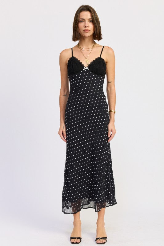 Black midi slip dress with lace bust and white polka dots, front view on model.