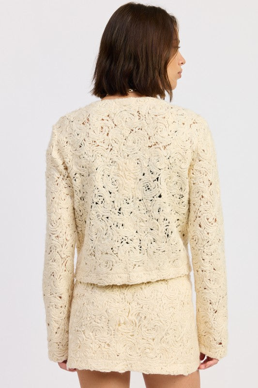 Back view of Ivory Reverie Textured Cropped Jacket highlighting detailed textured pattern and cropped fit.