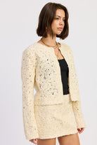 Side view of Ivory Reverie Textured Cropped Jacket showing relaxed silhouette and open neckline.