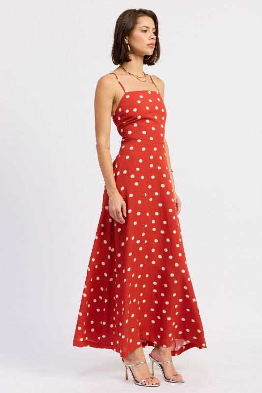 Side profile of the red polka dot maxi with fitted bodice and flared skirt.
