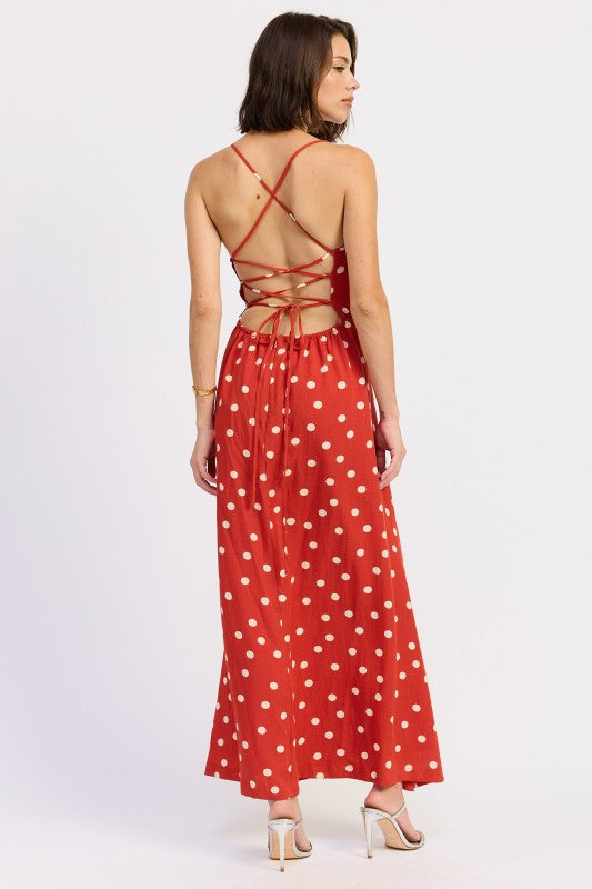 Model wearing the red polka dot dress with open lace-up back and criss-cross ties.