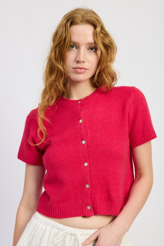 Fuchsia short sleeve knit cardigan worn buttoned, front angle