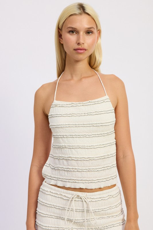 Front view of cream textured halter top with ruffle detailing and matching maxi skirt