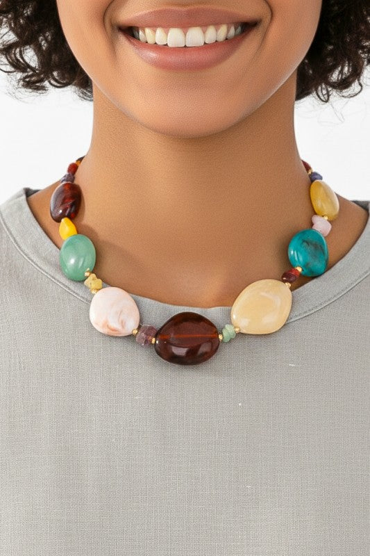 Multicolor marbled resin bead statement necklace worn with white sleeveless top