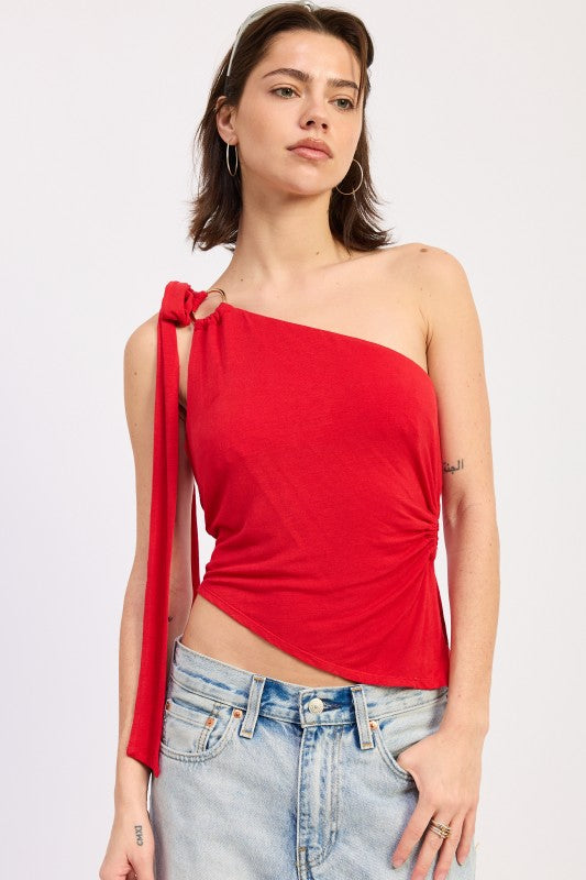 Front view of red one shoulder asymmetrical top with asymmetrical hem and ring detail