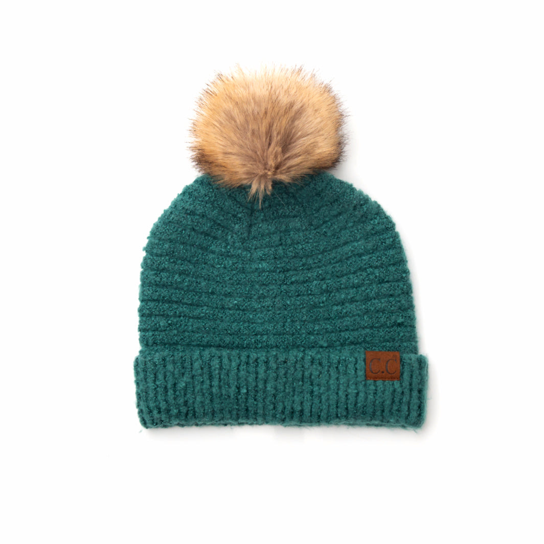 green boucle knit hat with faux fur pom