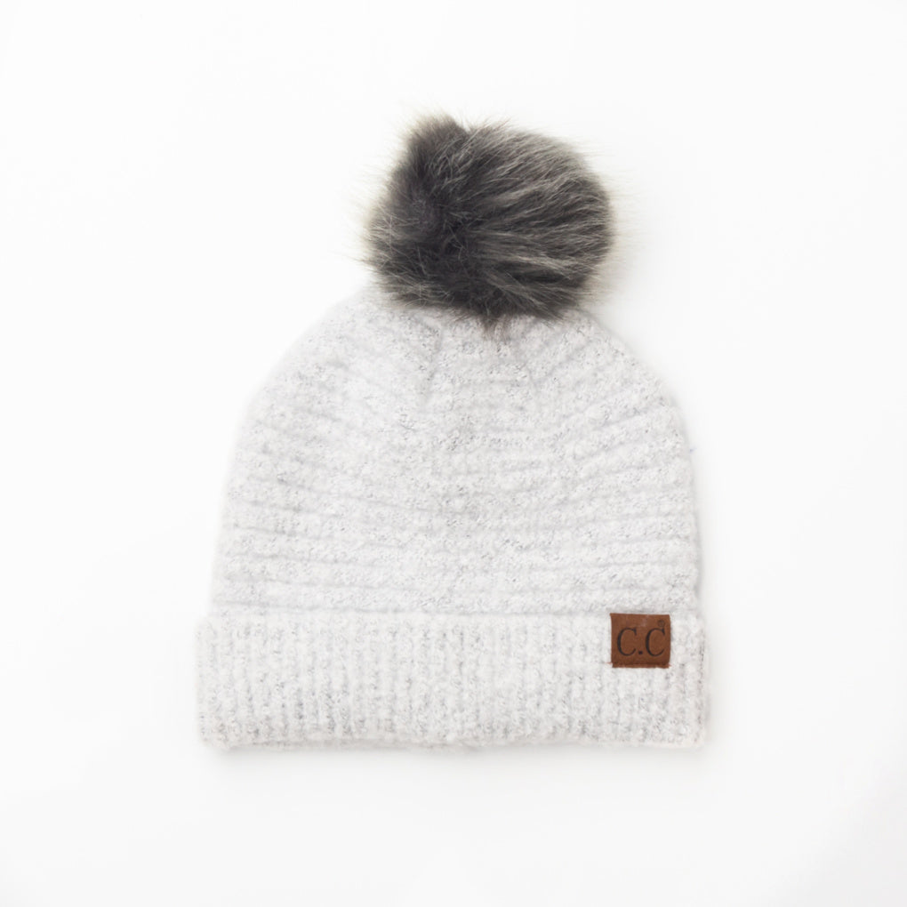 White boucle knit hat with faux fur pom