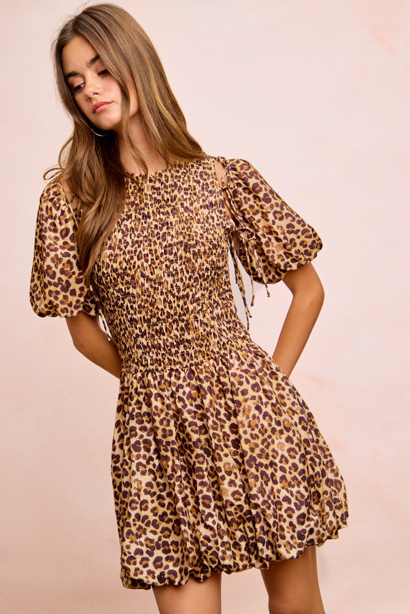 leopard print bubble hem mini dress with smocked bodice and puff sleeves front angled view