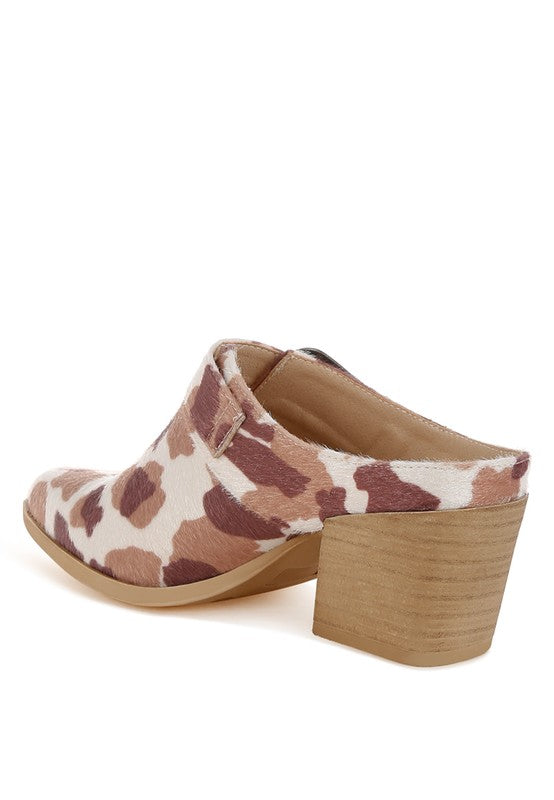 Back view showing heel and slip-on mule shape in cow print faux suede