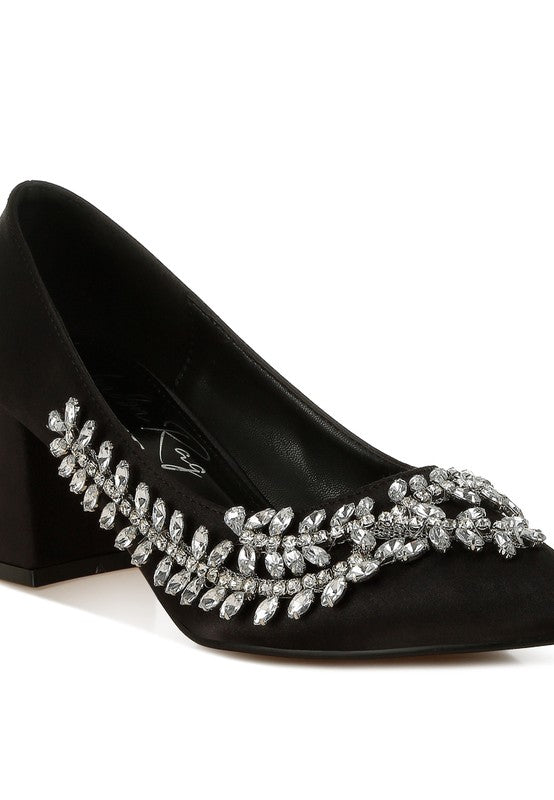 Close-up of black satin pointed-toe heel with crystals
