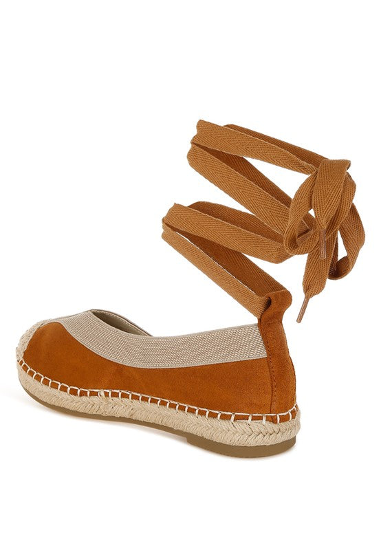 Back angle of tan espadrille with bow-tied wraparound ankle straps and canvas detail