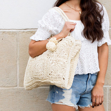 Nomadic Natura Straw Tote with artisan weave and pom-pom in straw