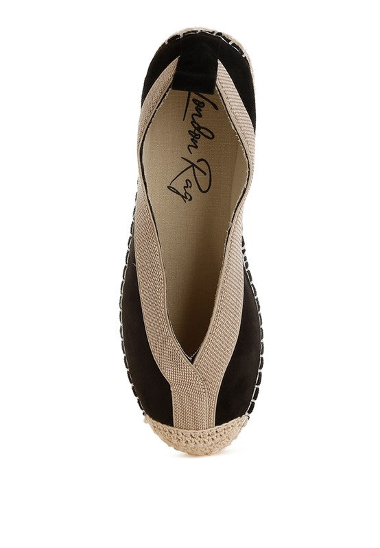 Top-down view of black espadrille showing deep V-cut beige trim and closed toe design