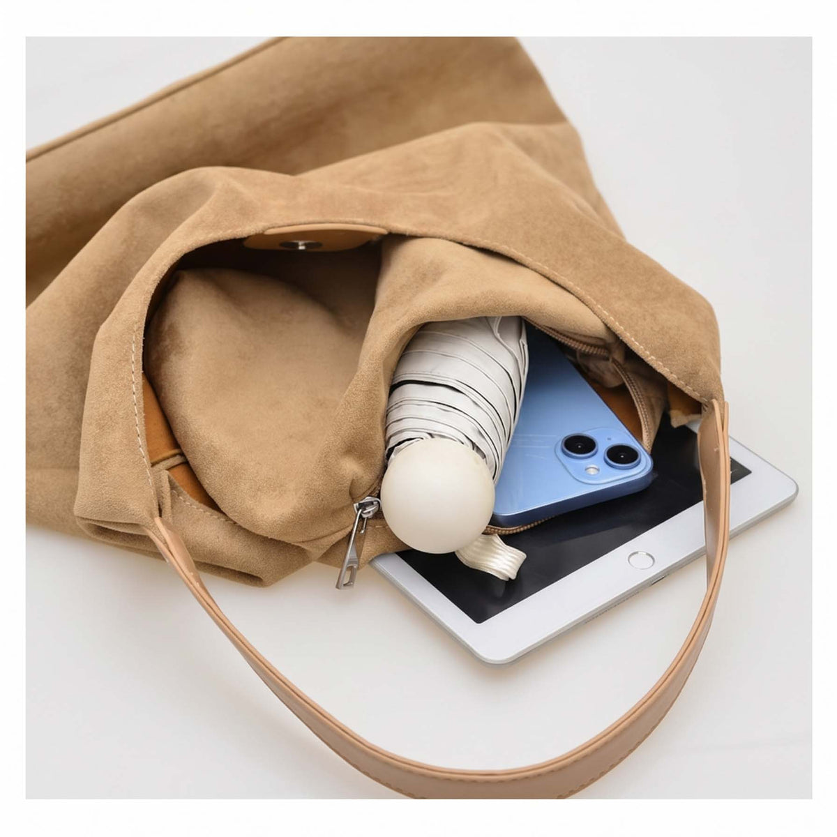 Open fawn suede-look hobo bag showing roomy unlined interior.