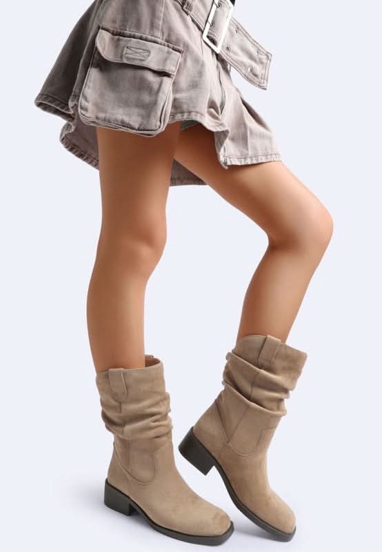 Model wearing taupe slouch faux suede boots styled with utility mini skirt-AVAH