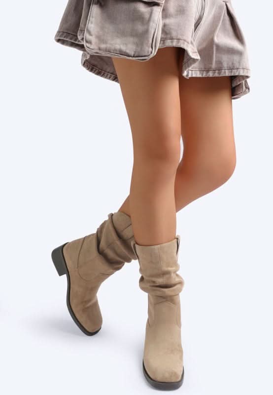 Taupe slouchy boots shown from side angle with relaxed shaft