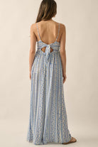 Back view of jumpsuit with self-tie bow, open-back detail, and adjustable cami straps