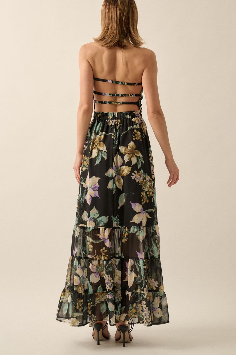 Back view of strapless floral maxi dress showing open back with three horizontal straps and ankle-length hem