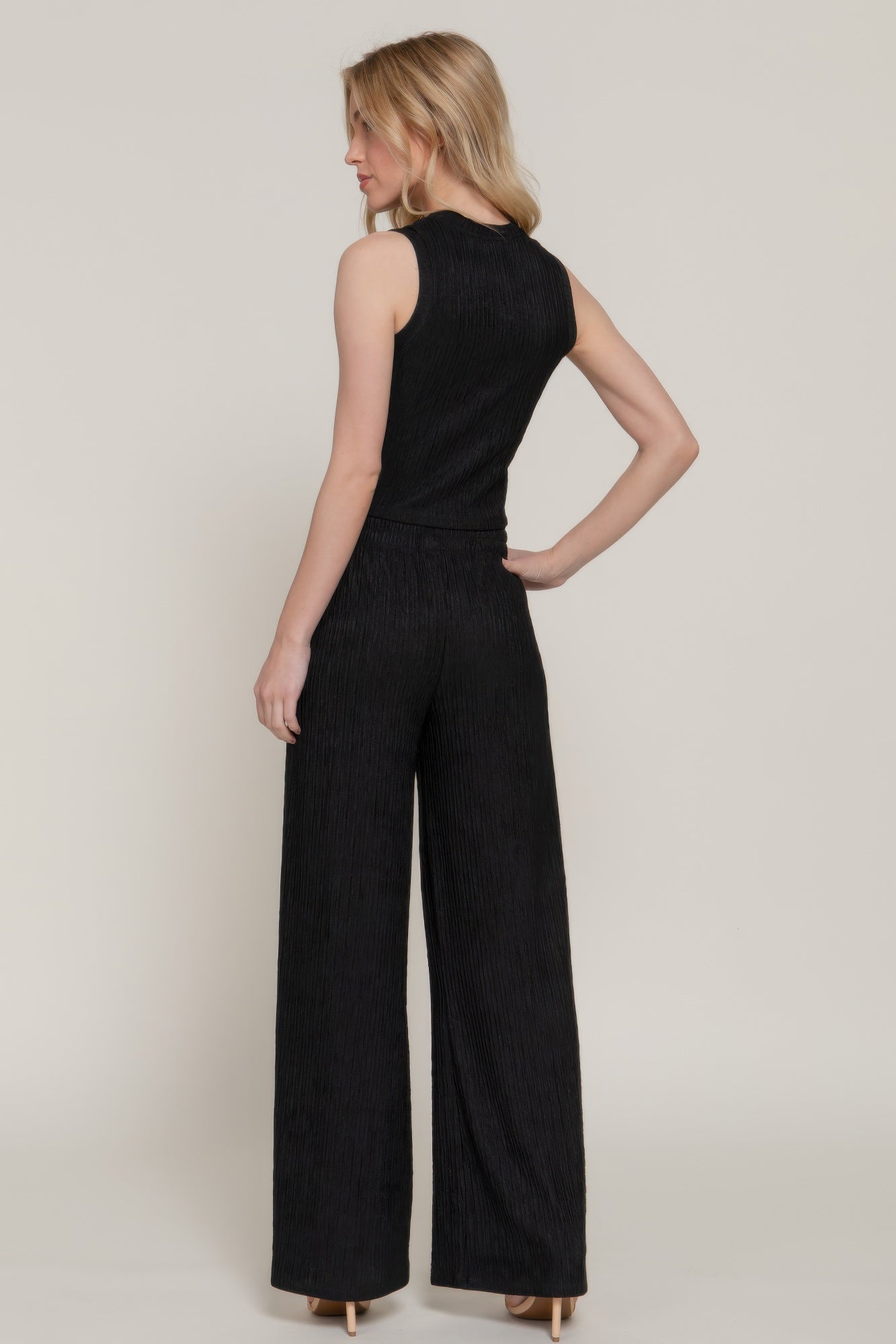 Rear view of model wearing wide leg pants and sleeveless top- matching set