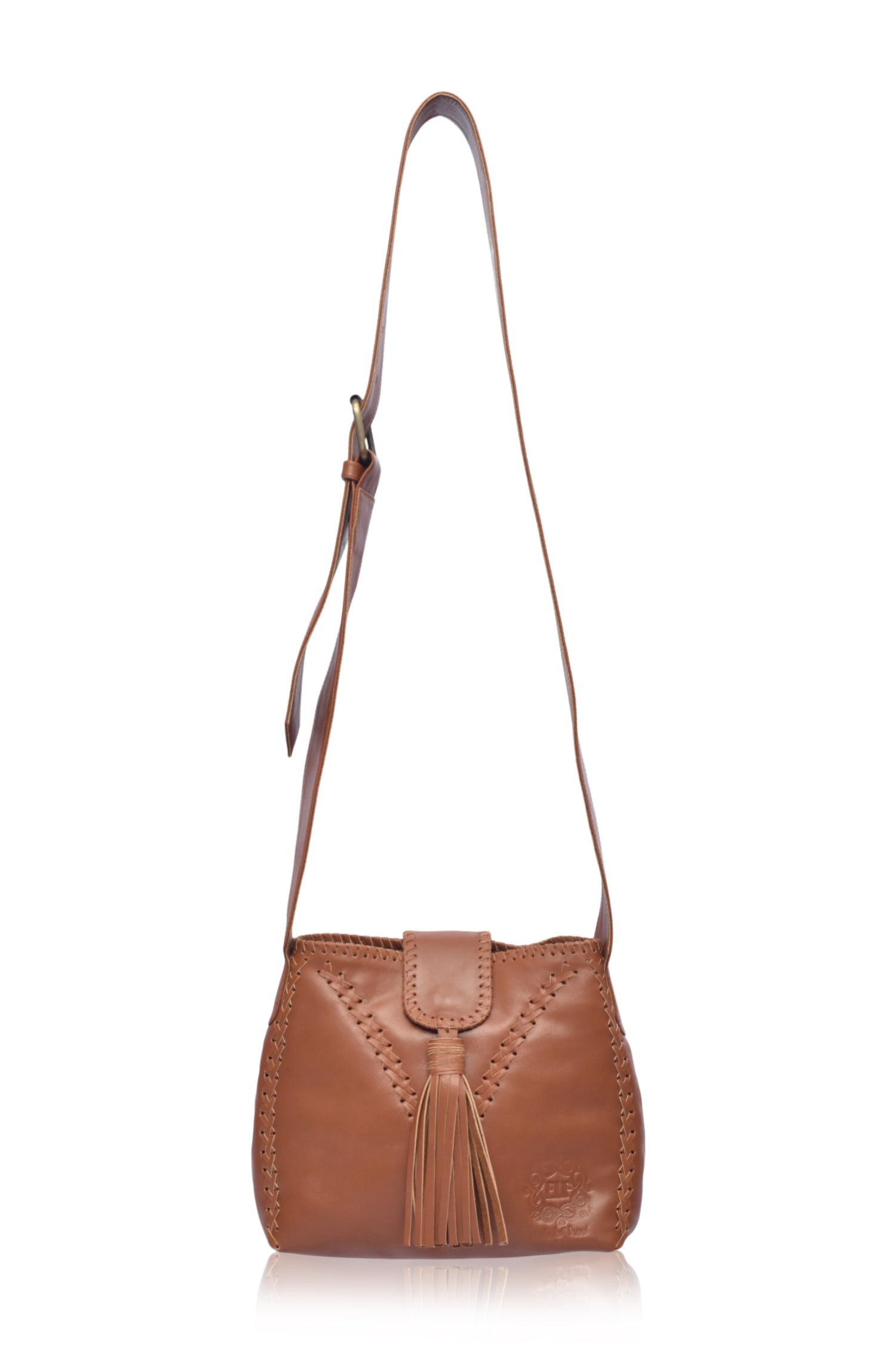 Camel leather handbag with fringe details and wide crossbody strap on a white background, front view
