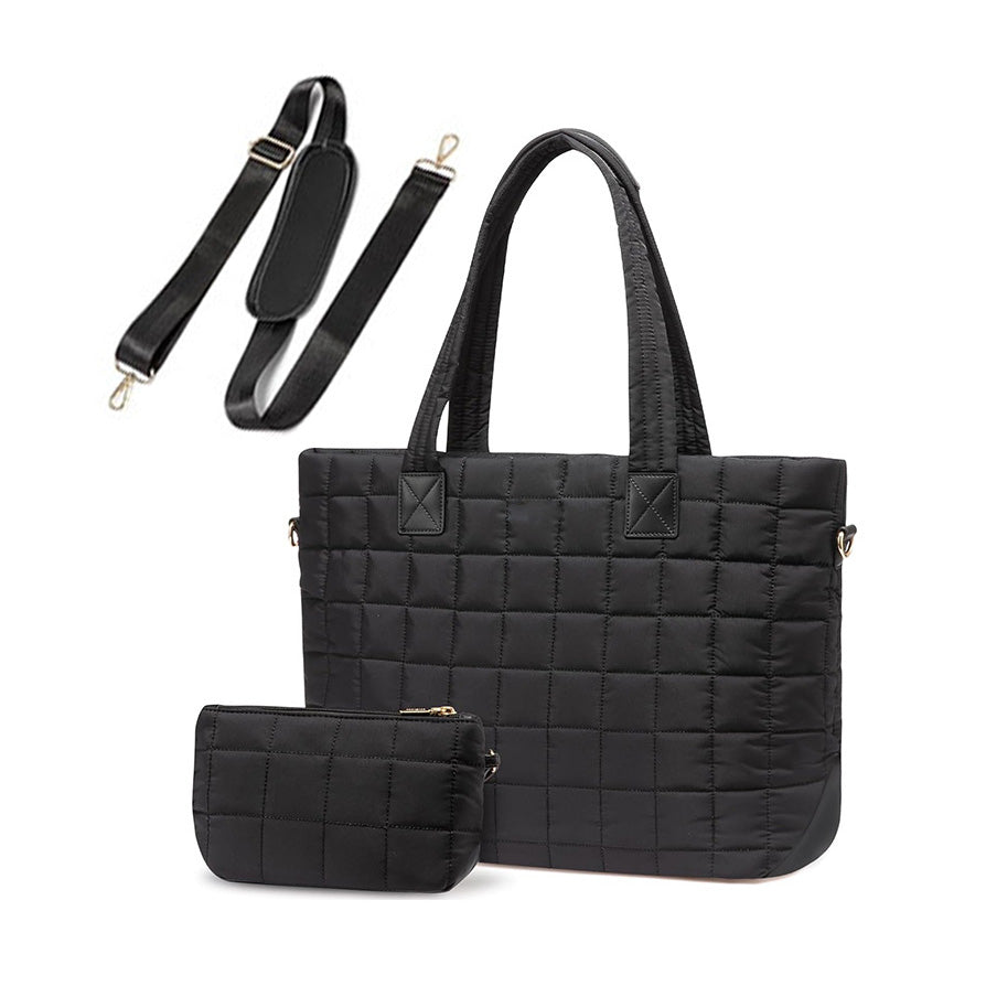 Black quilted travel tote with matching pouch on a white background