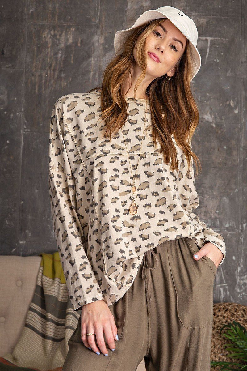 Front view of AVAH leopard print oversized knit top in sand beige with taupe and olive spots, featuring dolman sleeves and relaxed round neckline.