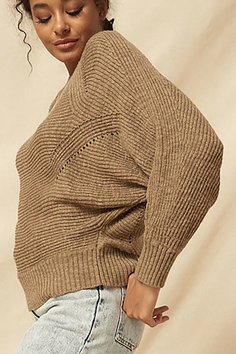 Taupe rib knit boatneck sweater with relaxed silhouette and ribbed hem, styled casually with pearl-embellished denim.
