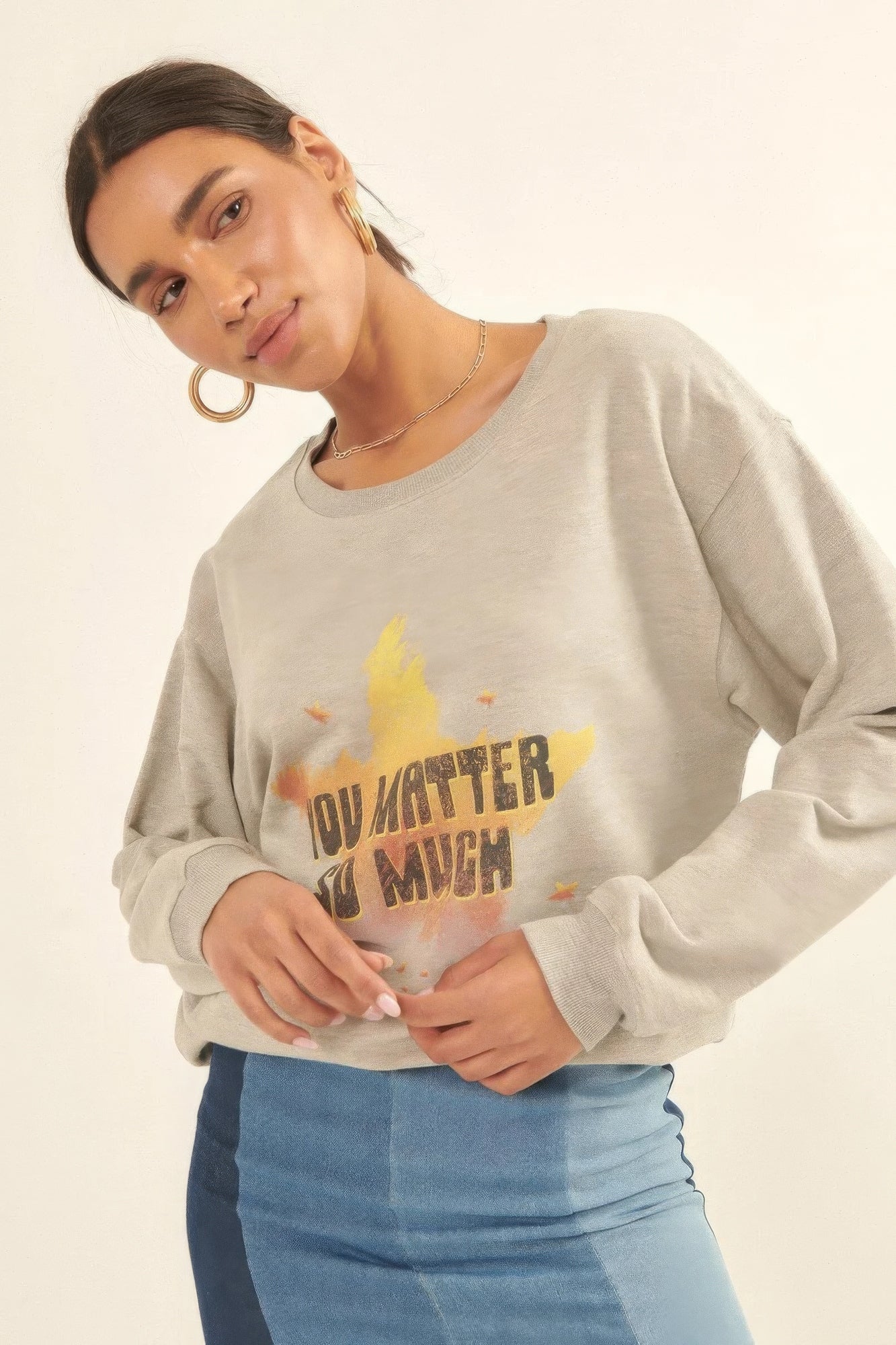 Casual styled Radiance Reminder Graphic Sweatshirt paired with denim mini skirt