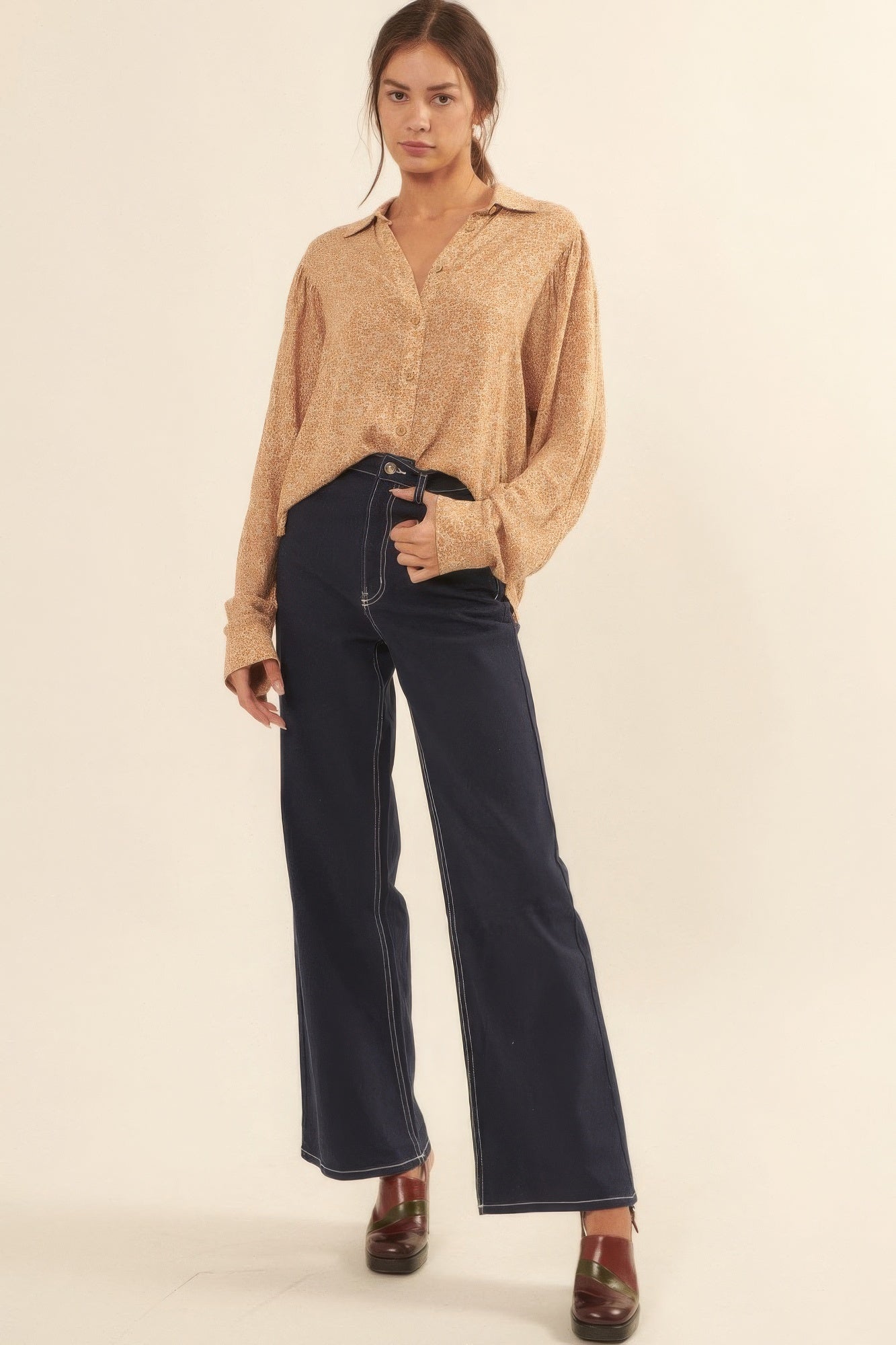 Full outfit view of golden floral print blouse tucked into dark high-rise jeans-AVAH