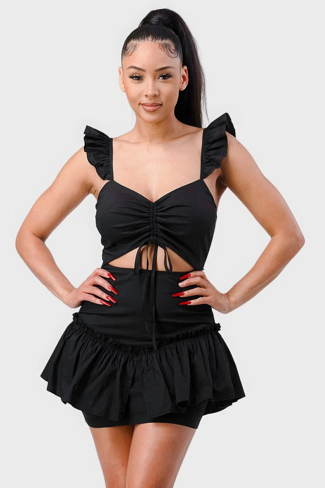 Black mini dress with ruched sweetheart neckline and ruffle hem, front view