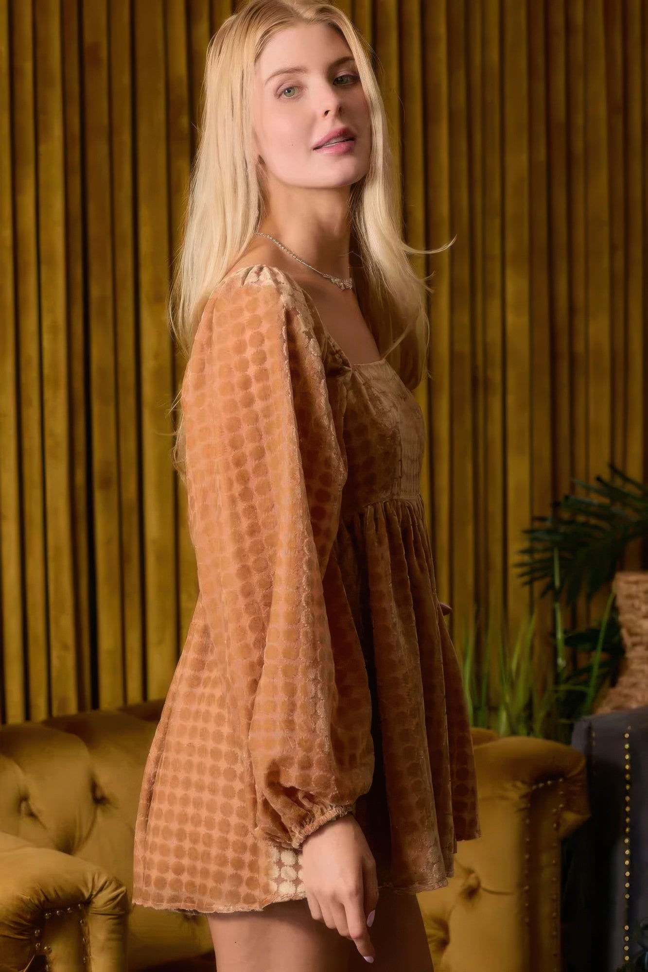 Side view of velvet romper with relaxed flared shorts and long sleeves-AVAH