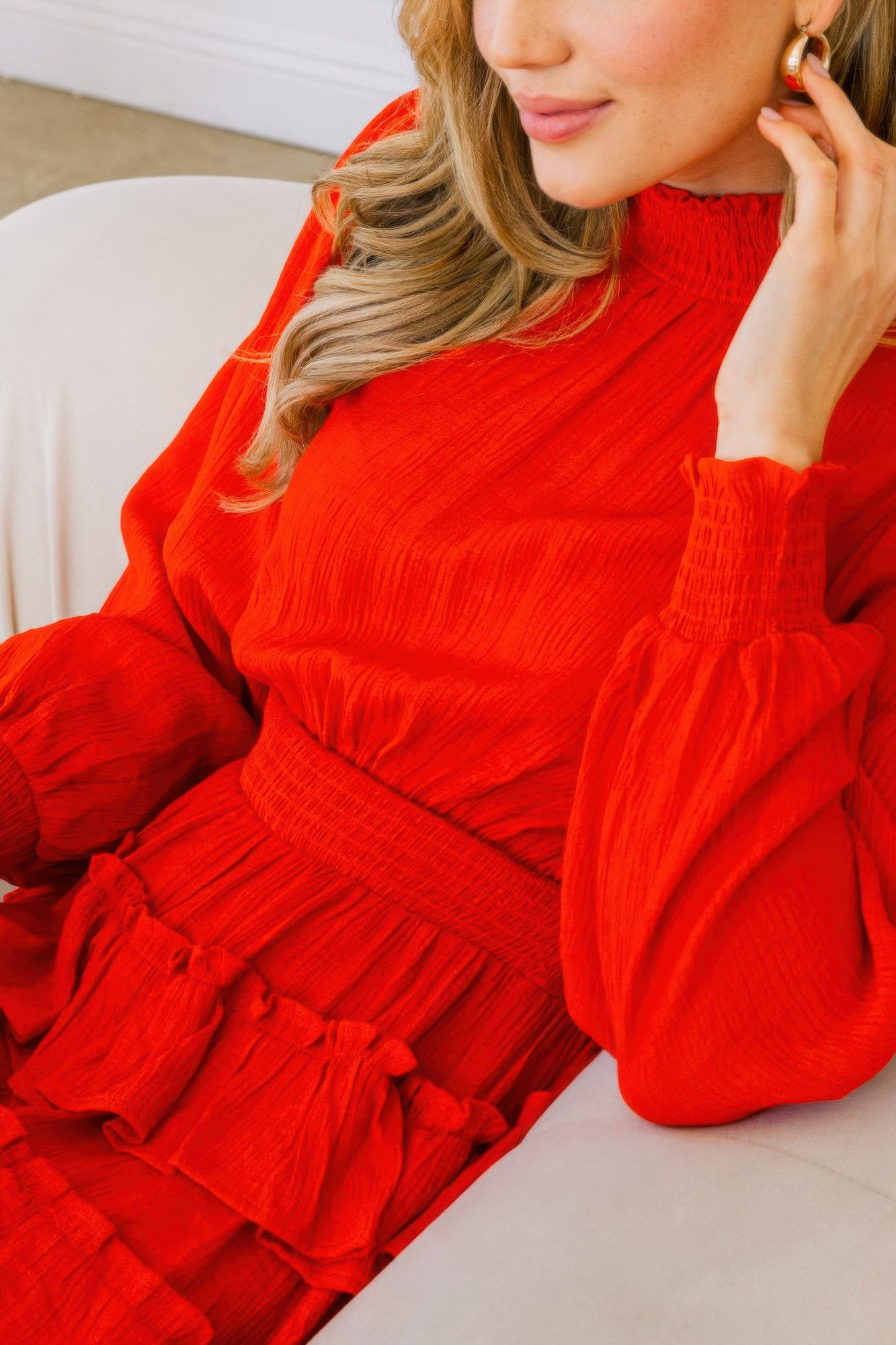 Close-up of red long sleeve smocked mini dress showing tiered ruffle waist detail-AVAH
