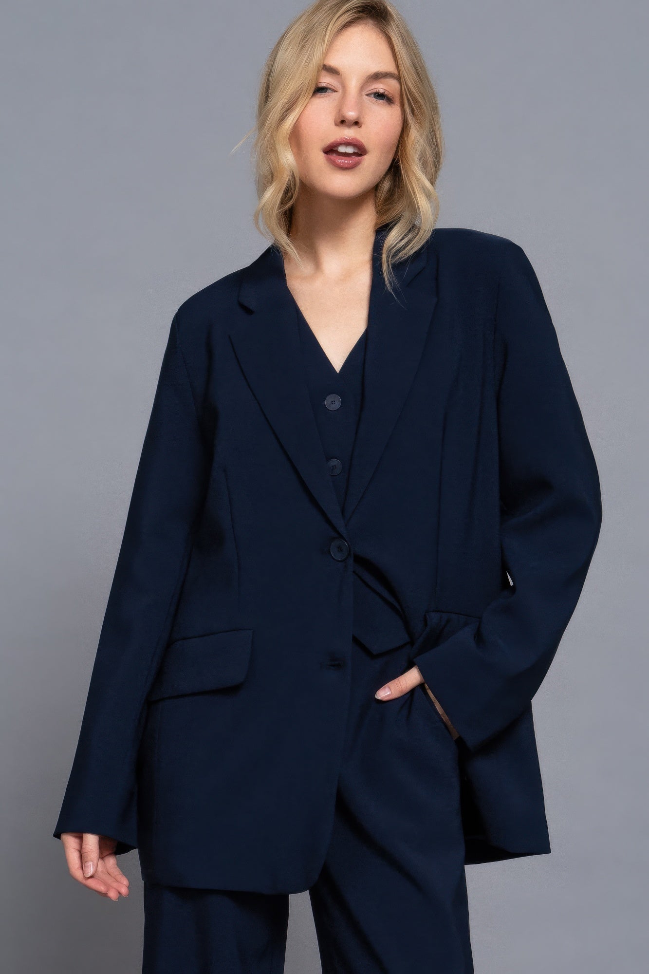 Front view of oversized navy blazer with notched lapels and button closure-AVAH