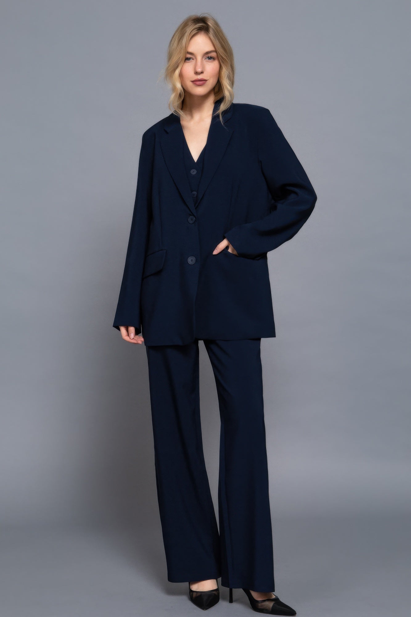Full body view of model wearing oversized navy blazer with straight leg pants-AVAH