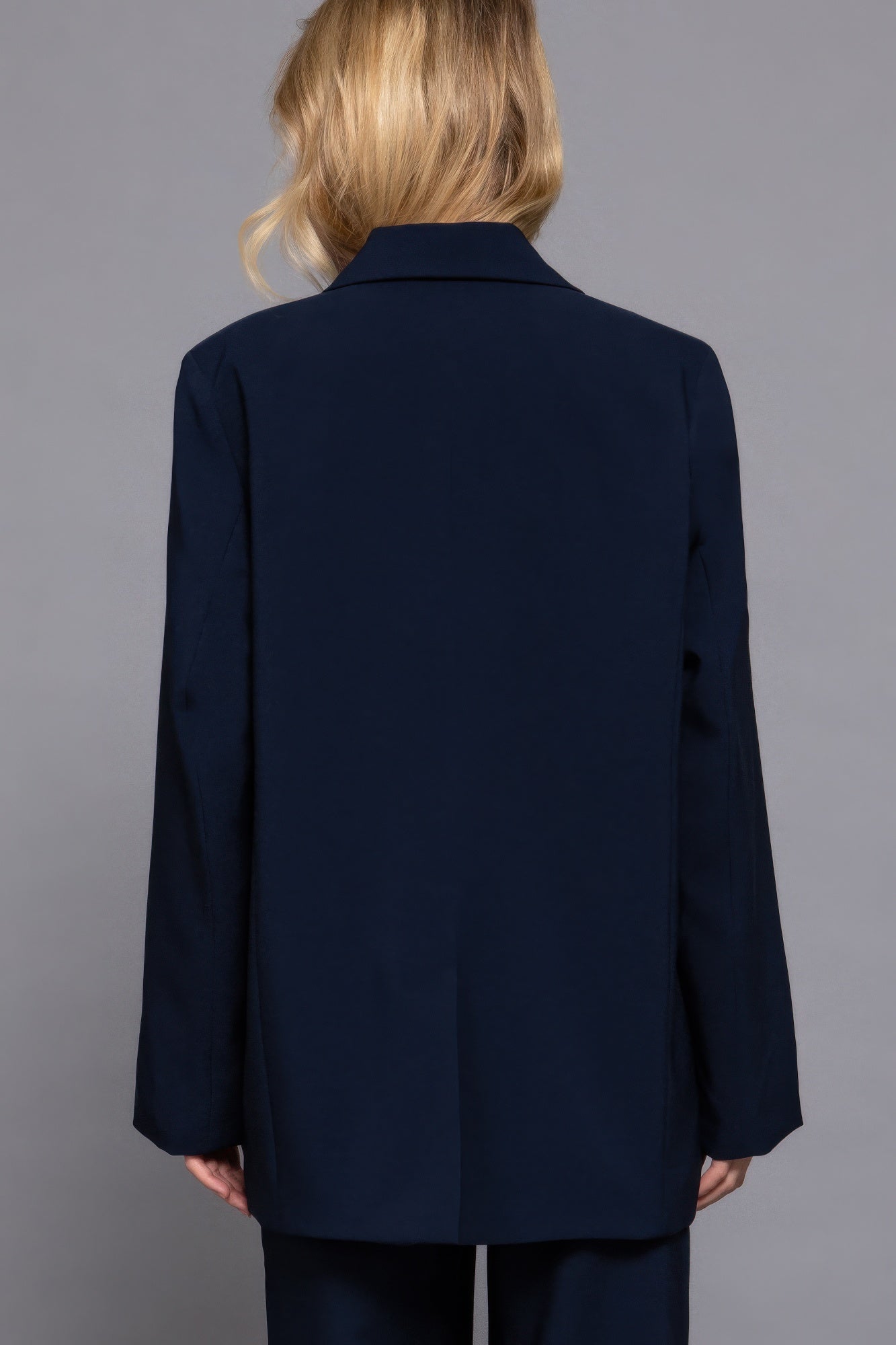 Back view of oversized navy blazer showing relaxed drape and longline cut-AVAH