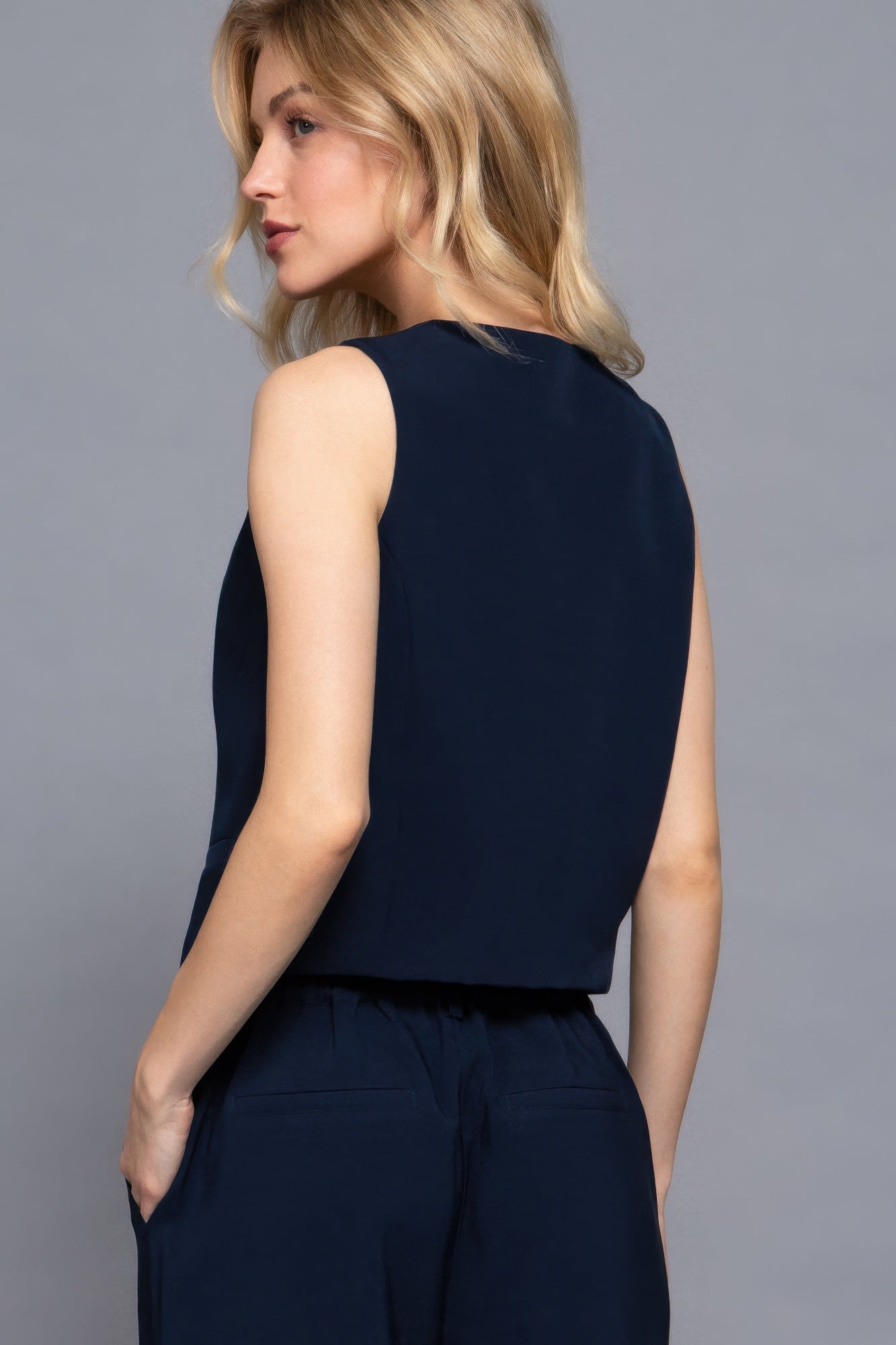 Back view of navy sleeveless vest showing clean tailored silhouette-AVAH