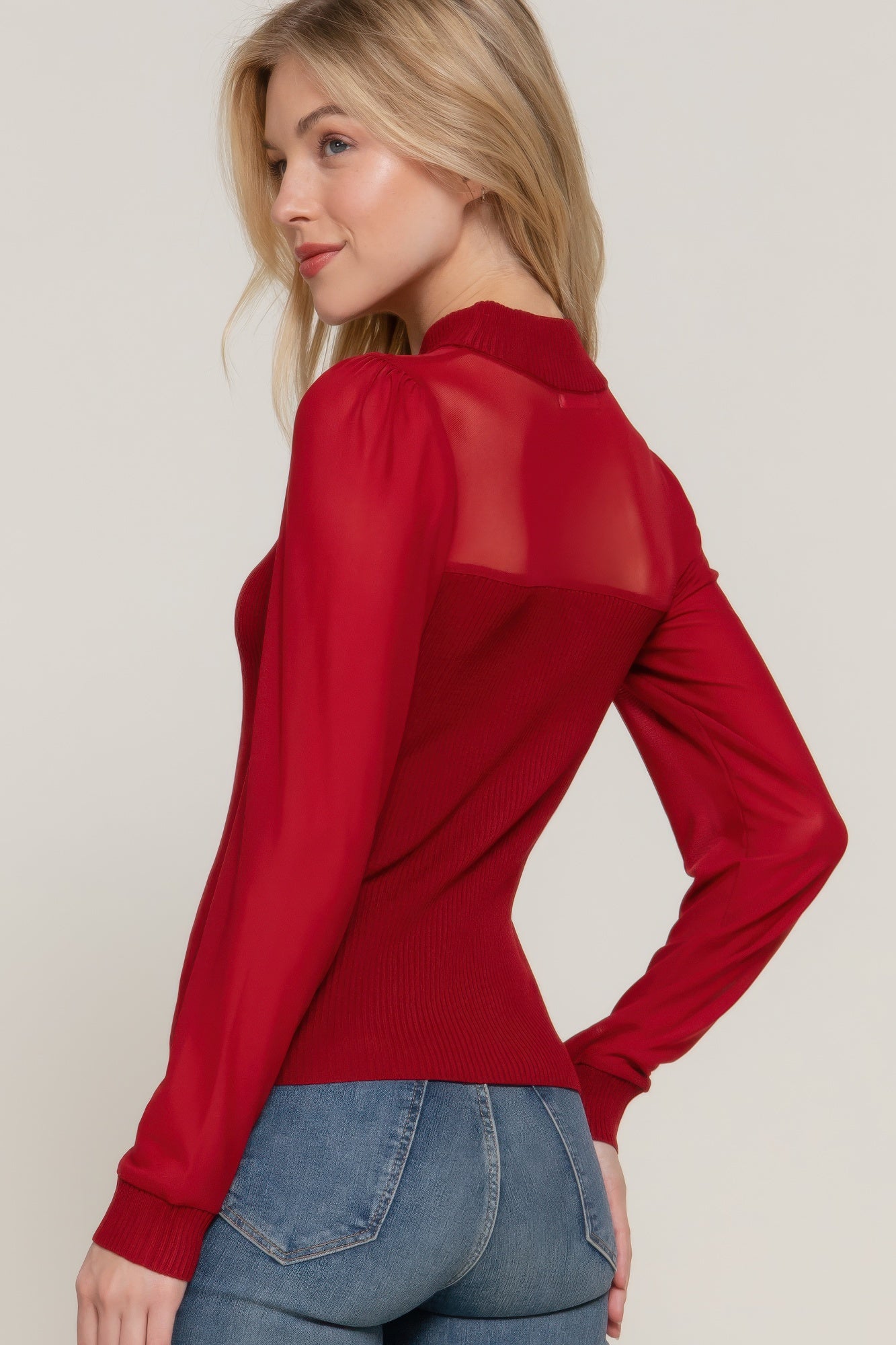 Back of ribbed knit red sweater top featuring clean lines and subtly rounded hem and sheer sleeves-AVAH