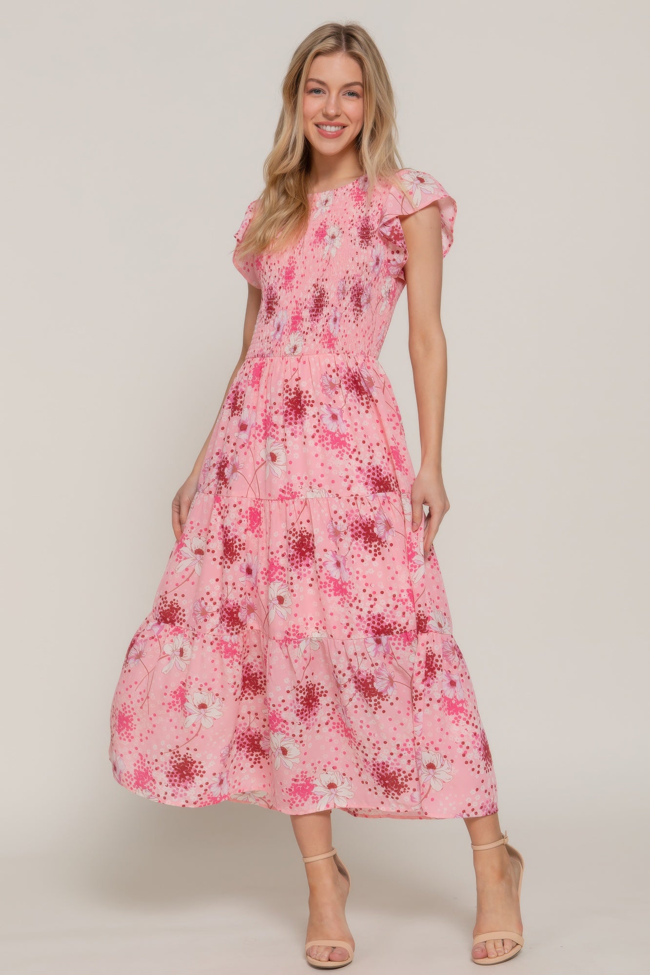 Front view of pink floral smocked maxi dress with flutter sleeves and tiered skirt-AVAH